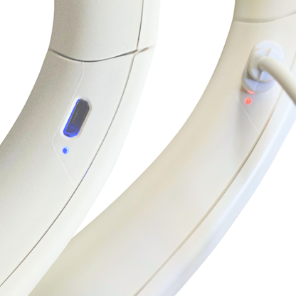 Close-up of AZZARUS rechargeable bladeless neck fan showing charging port with red LED while charging and green light when fully charged